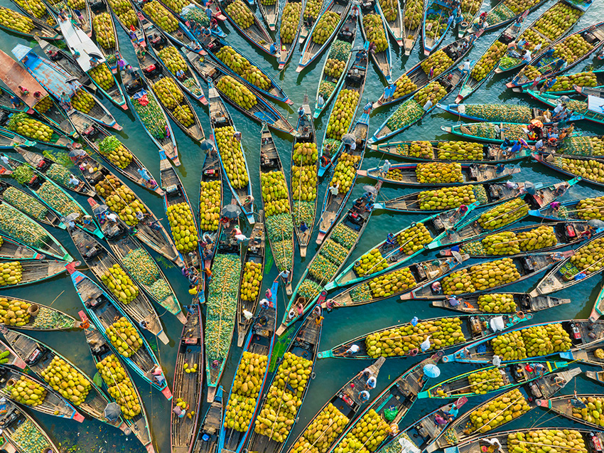 Aerial view of many rowing boats with produce