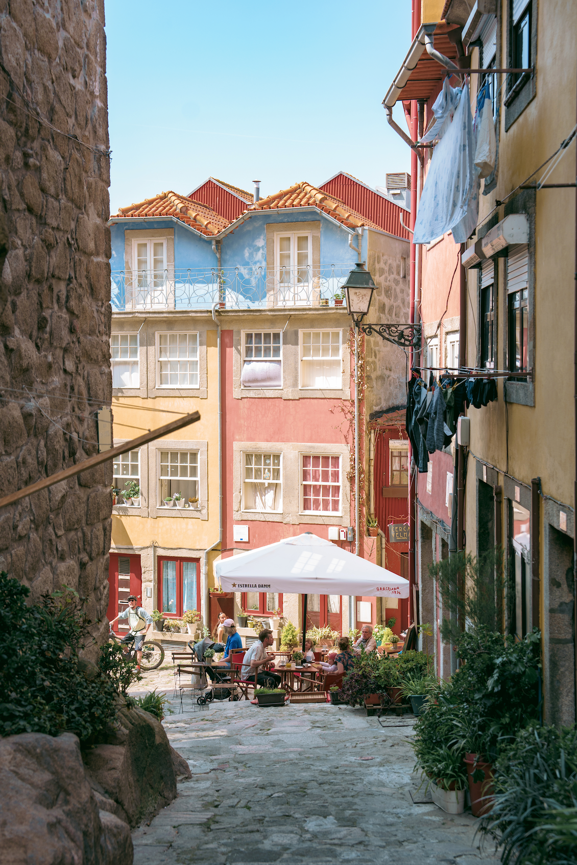 Walkway between buildings with an alfresco restaurant at the end of the path