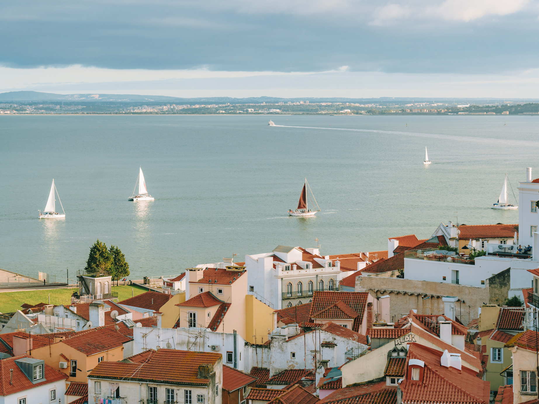 View of the sea with a few sailboats from a lookout in town