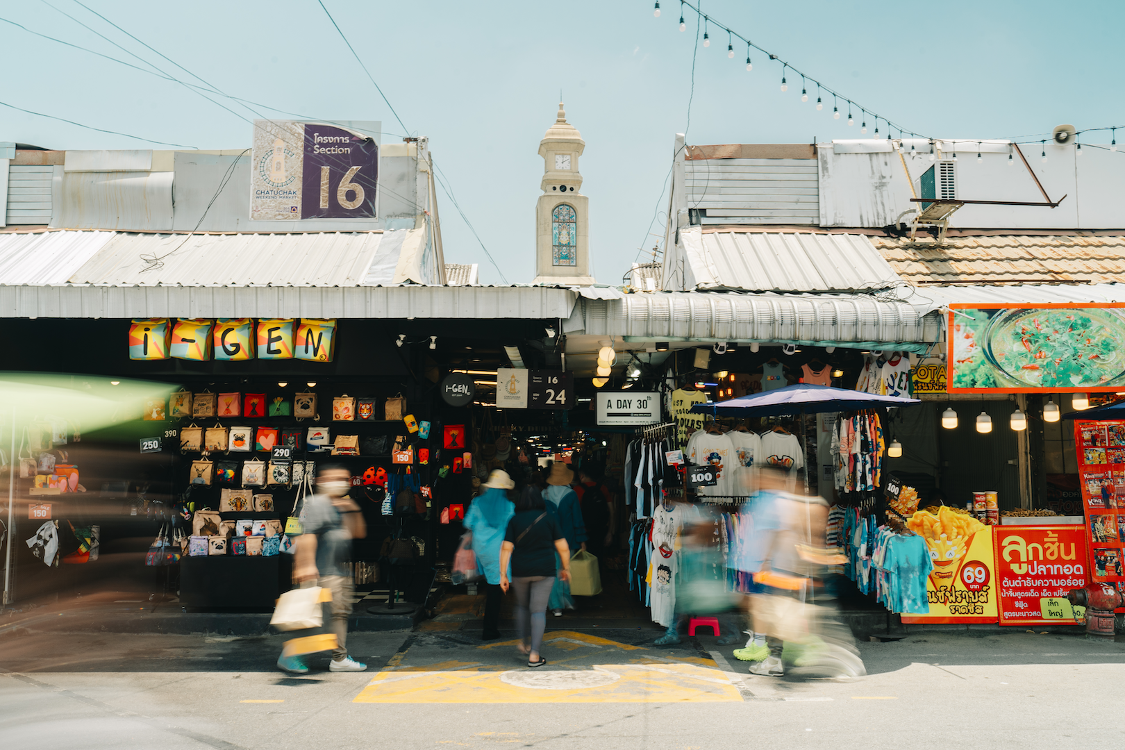 People entering into the Chatuchak Market amidst passerbys