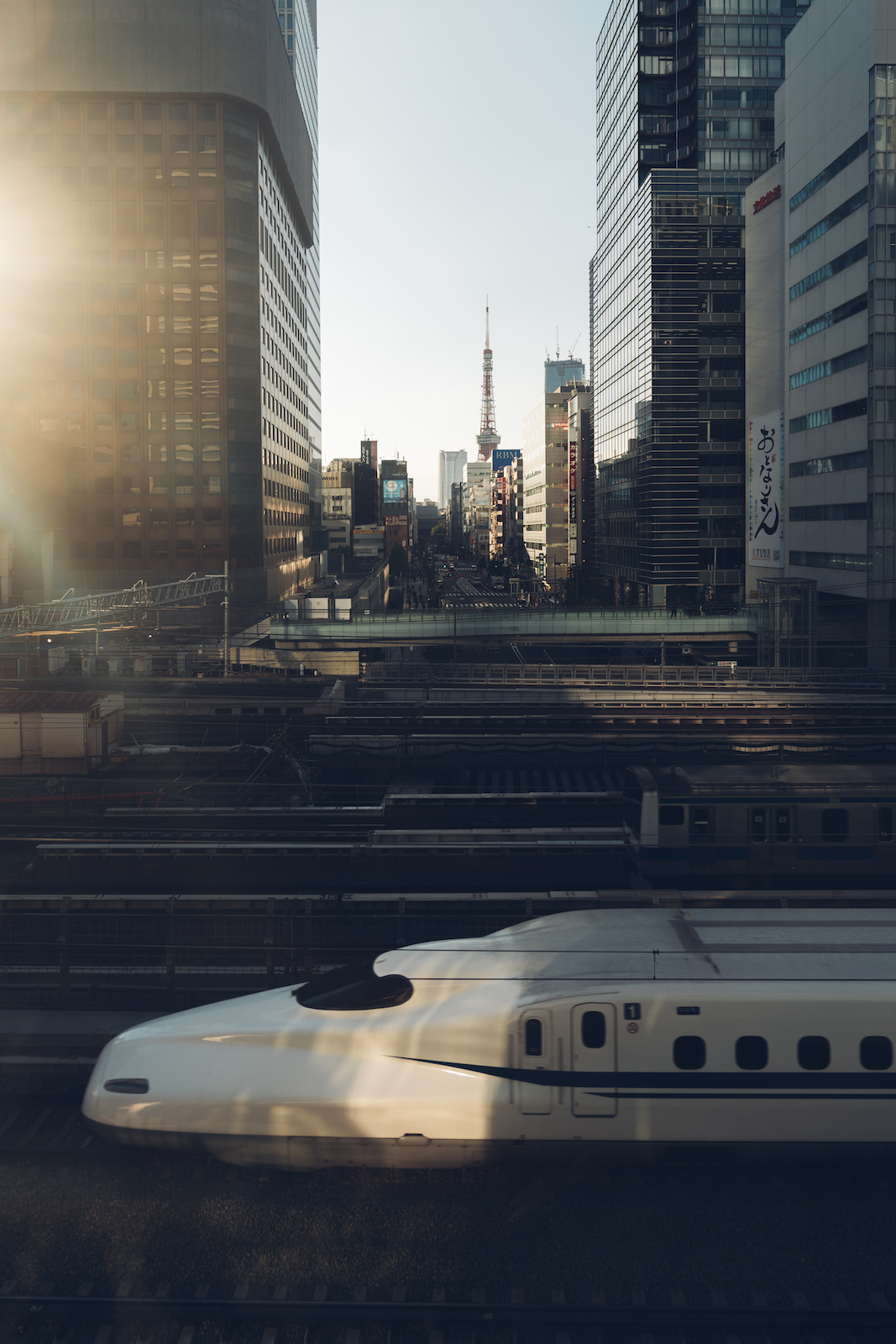 Bullet train shuttling across the city in the morning, with high-rise buildings in the background