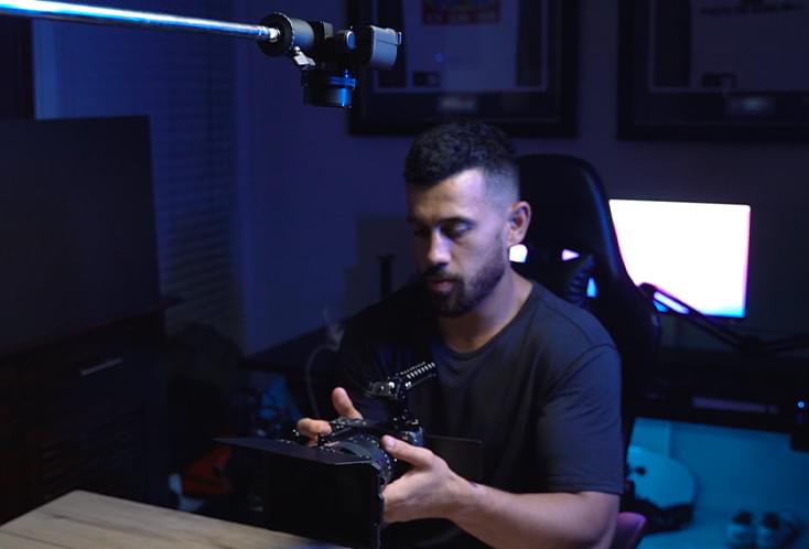 Jordan Kahu holding the Sony ZV-E10 in his studio